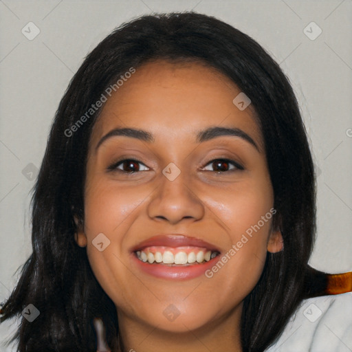 Joyful latino young-adult female with long  black hair and brown eyes