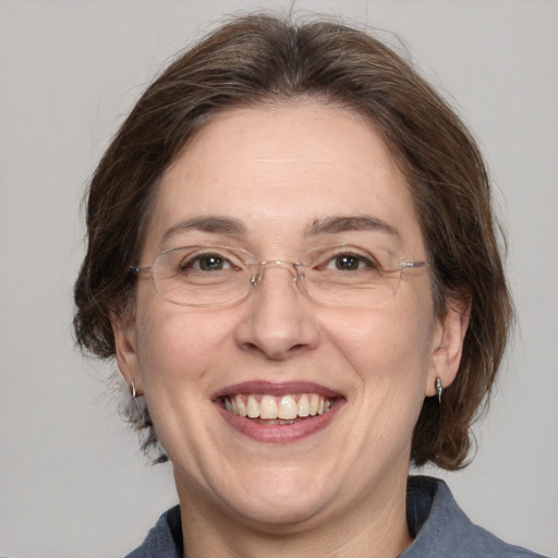 Joyful white adult female with medium  brown hair and grey eyes