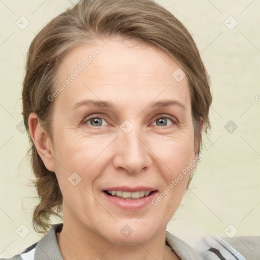 Joyful white adult female with medium  brown hair and grey eyes