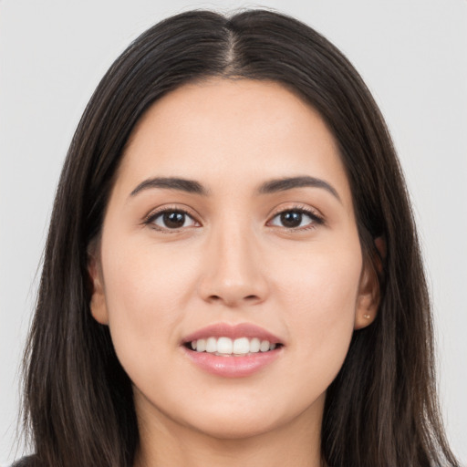 Joyful white young-adult female with long  brown hair and brown eyes