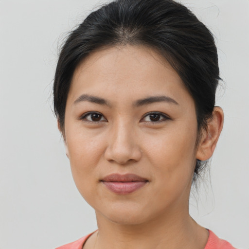 Joyful latino young-adult female with medium  brown hair and brown eyes