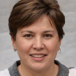 Joyful white adult female with medium  brown hair and brown eyes