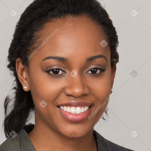 Joyful black young-adult female with long  brown hair and brown eyes