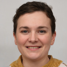 Joyful white young-adult female with short  brown hair and grey eyes