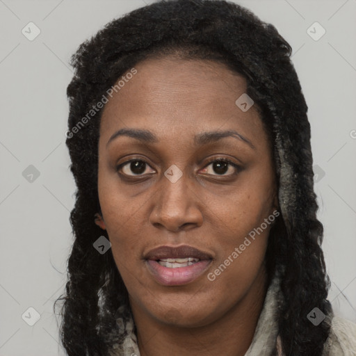 Joyful black young-adult female with long  brown hair and brown eyes