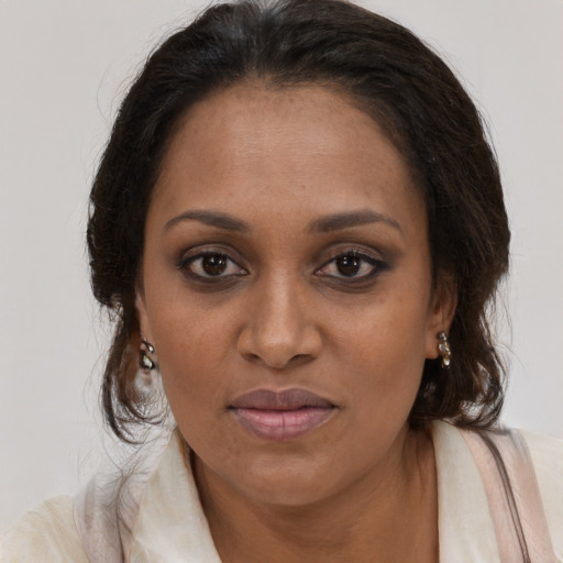 Joyful black young-adult female with long  brown hair and brown eyes