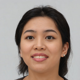 Joyful asian young-adult female with medium  black hair and brown eyes