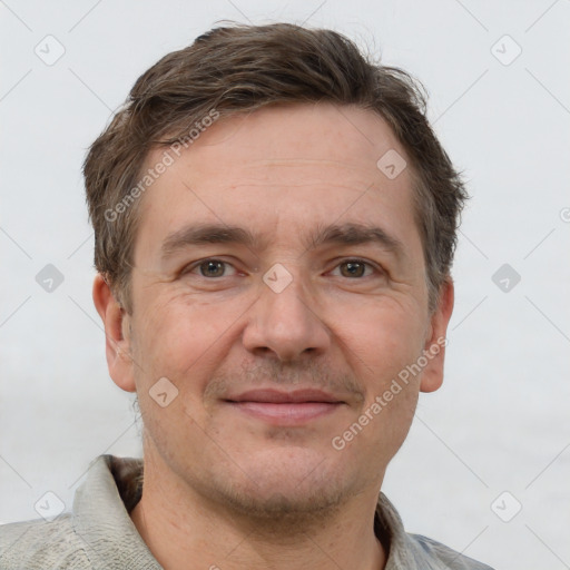 Joyful white adult male with short  brown hair and grey eyes