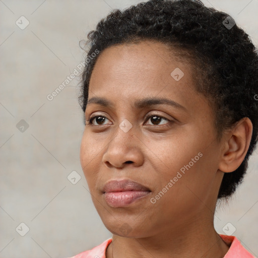 Joyful black young-adult female with short  black hair and brown eyes