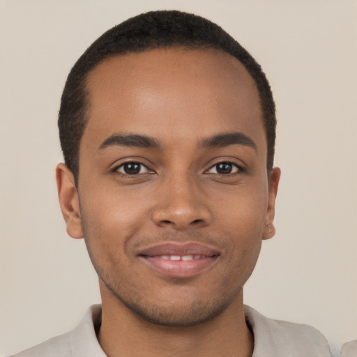 Joyful latino young-adult male with short  brown hair and brown eyes