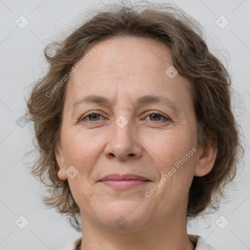 Joyful white adult female with medium  brown hair and grey eyes