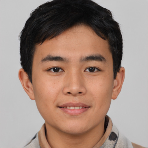 Joyful asian young-adult male with short  brown hair and brown eyes
