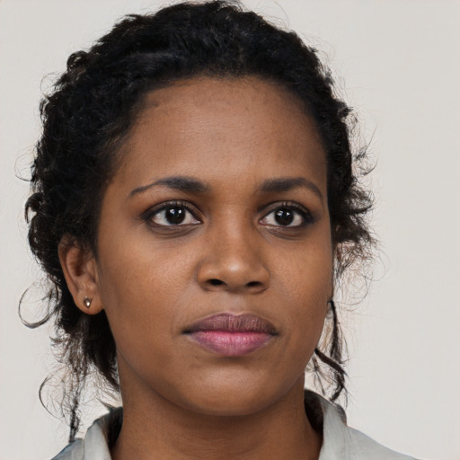Neutral black young-adult female with long  brown hair and brown eyes