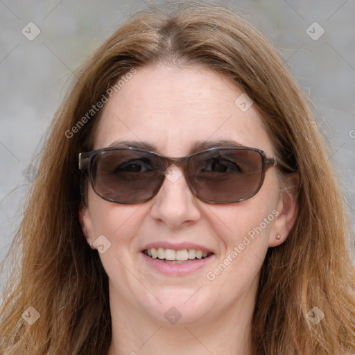 Joyful white adult female with medium  brown hair and blue eyes