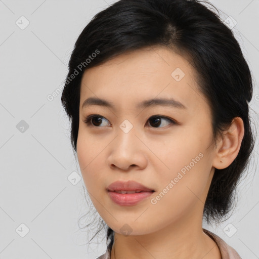 Joyful asian young-adult female with medium  black hair and brown eyes