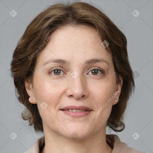 Joyful white adult female with medium  brown hair and grey eyes