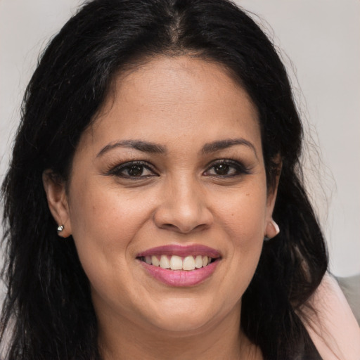 Joyful latino young-adult female with long  brown hair and brown eyes