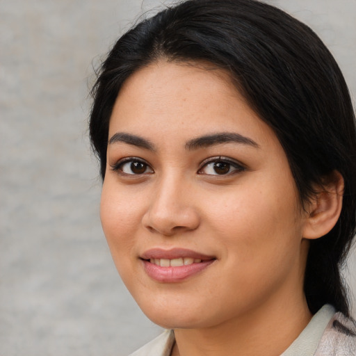 Joyful latino young-adult female with medium  black hair and brown eyes