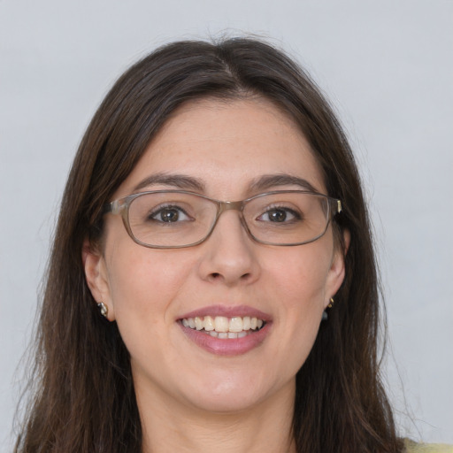 Joyful white young-adult female with long  brown hair and grey eyes