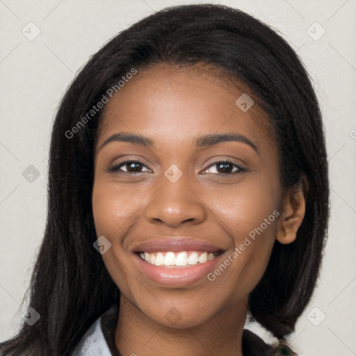 Joyful black young-adult female with long  black hair and brown eyes