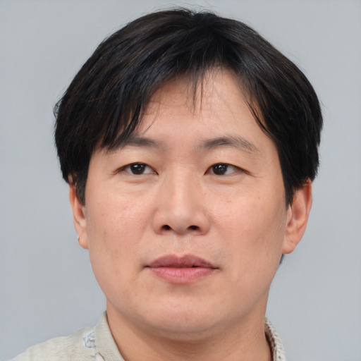 Joyful asian adult male with short  brown hair and brown eyes
