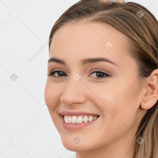 Joyful white young-adult female with long  brown hair and brown eyes