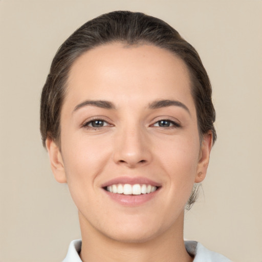 Joyful white young-adult female with short  brown hair and brown eyes