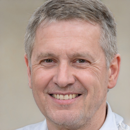 Joyful white middle-aged male with short  gray hair and brown eyes