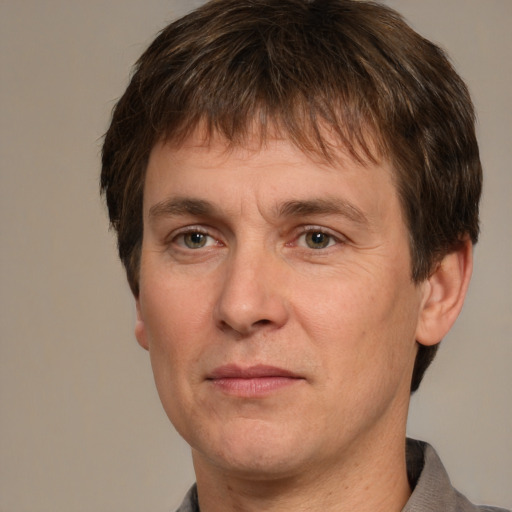 Joyful white adult male with short  brown hair and grey eyes