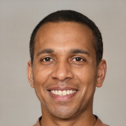 Joyful latino adult male with short  black hair and brown eyes