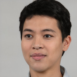 Joyful asian young-adult male with short  black hair and brown eyes