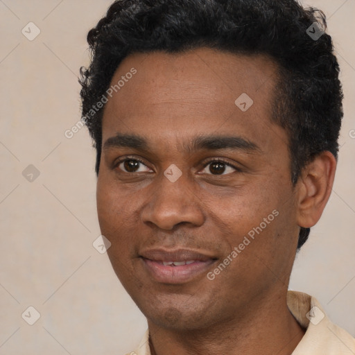 Joyful black young-adult male with short  black hair and brown eyes