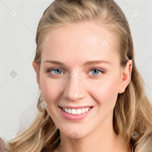 Joyful white young-adult female with long  brown hair and blue eyes