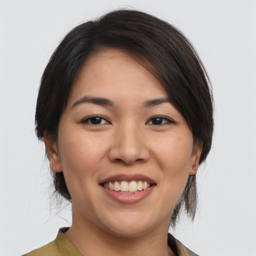 Joyful asian young-adult female with medium  brown hair and brown eyes