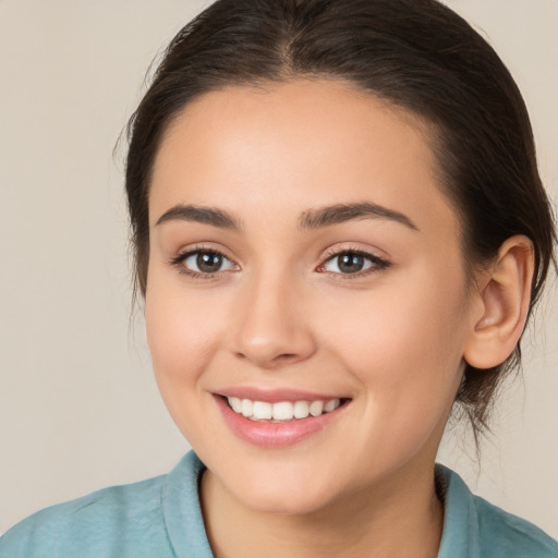 Joyful white young-adult female with medium  brown hair and brown eyes