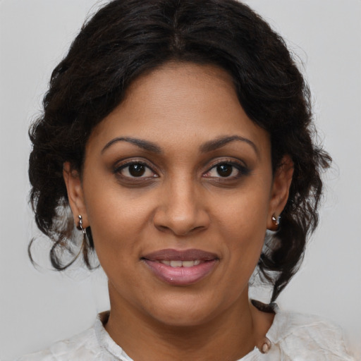 Joyful black young-adult female with medium  brown hair and brown eyes