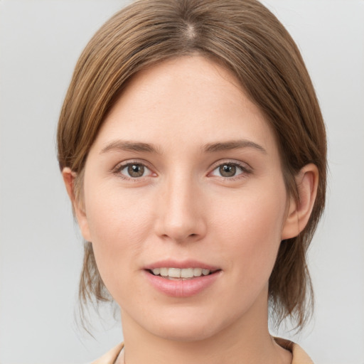 Joyful white young-adult female with medium  brown hair and brown eyes