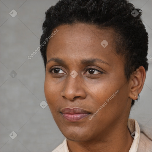 Joyful black young-adult female with short  black hair and brown eyes