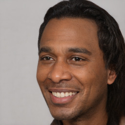 Joyful black adult male with short  black hair and brown eyes