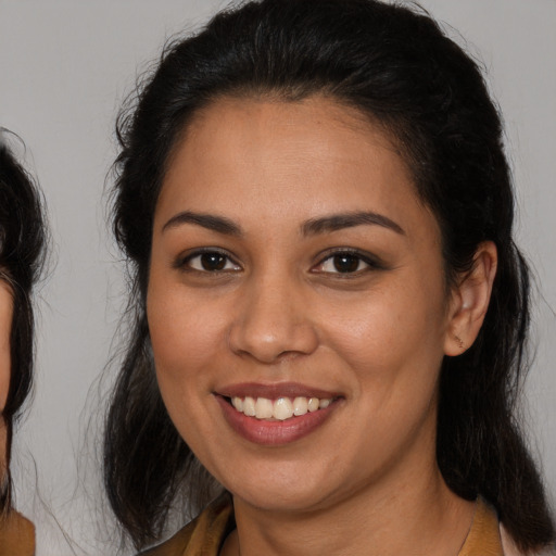 Joyful white young-adult female with long  brown hair and brown eyes