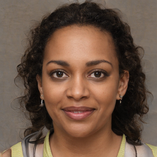 Joyful black young-adult female with medium  brown hair and brown eyes