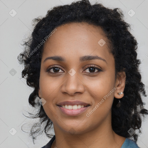 Joyful black young-adult female with long  black hair and brown eyes