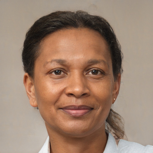 Joyful black adult female with short  brown hair and brown eyes