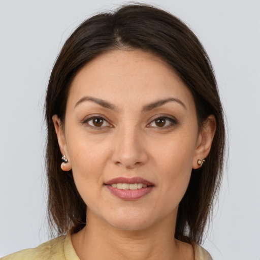Joyful white young-adult female with medium  brown hair and brown eyes