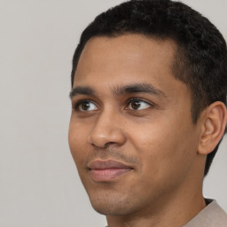 Joyful latino young-adult male with short  black hair and brown eyes