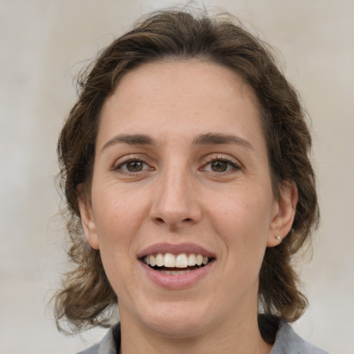 Joyful white young-adult female with medium  brown hair and green eyes