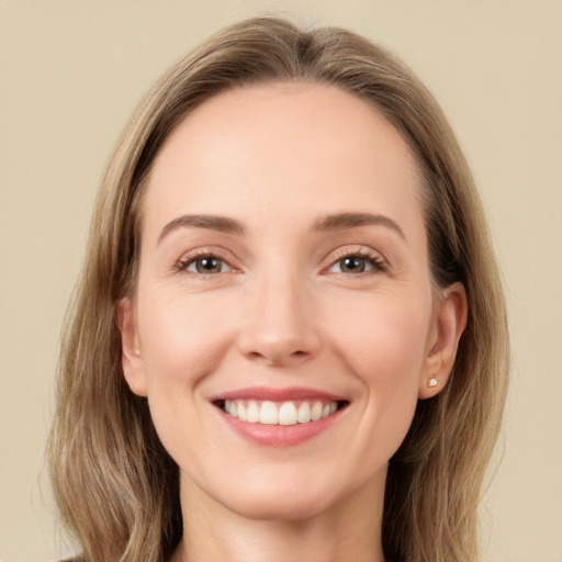 Joyful white young-adult female with long  brown hair and green eyes