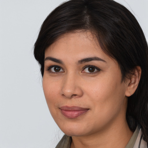 Joyful latino young-adult female with medium  brown hair and brown eyes