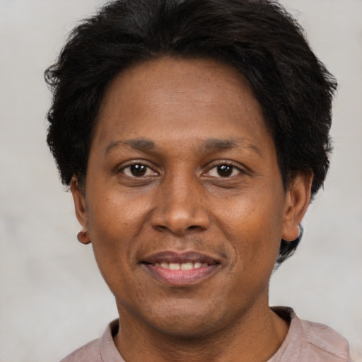 Joyful black adult female with short  brown hair and brown eyes