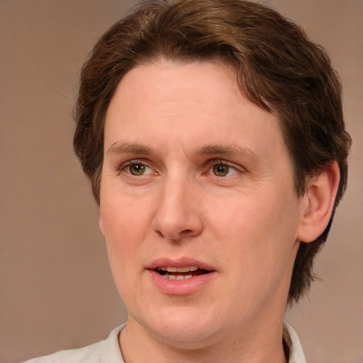 Joyful white adult female with medium  brown hair and green eyes